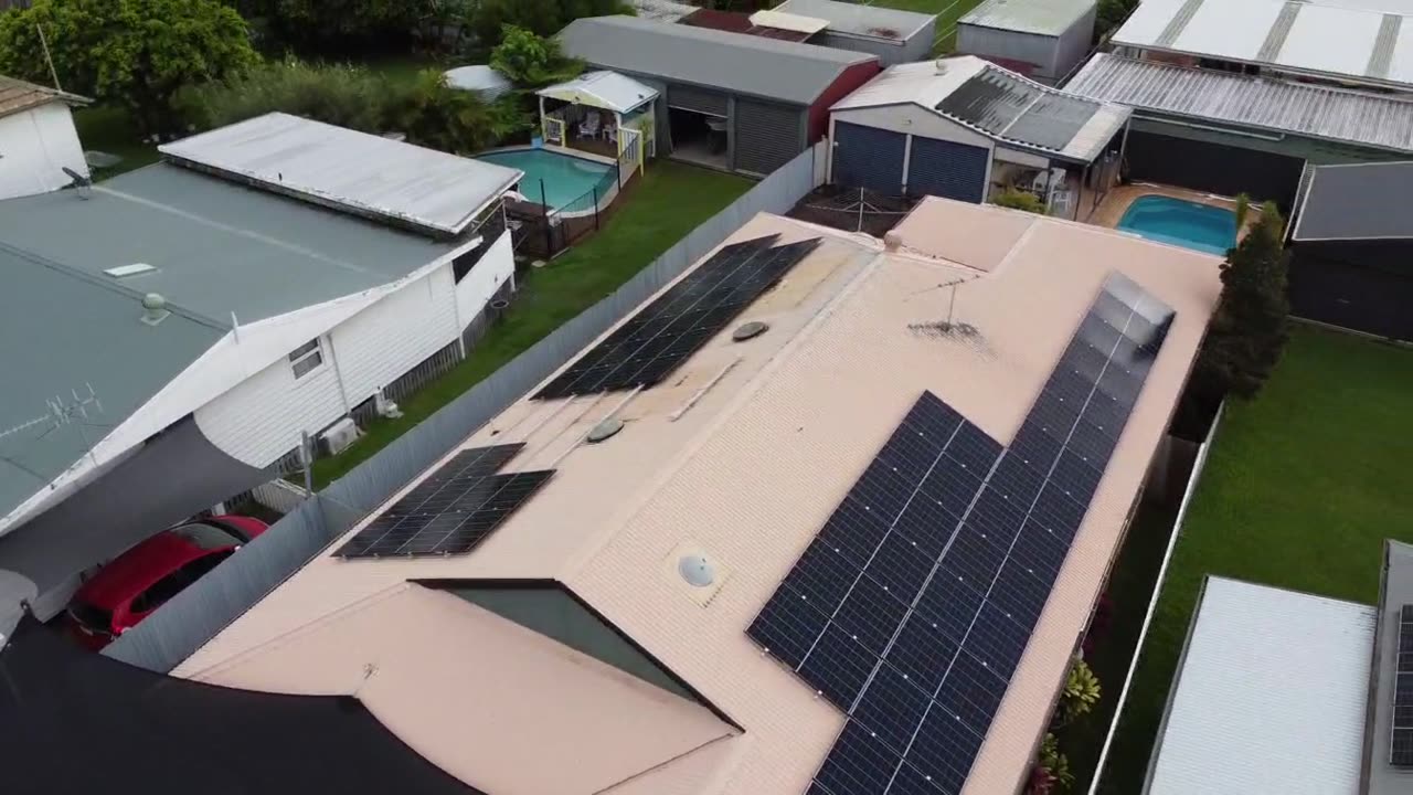 Aerial view of rooftop solar panels installed by Enhance Electrical and Solar on a metal roof