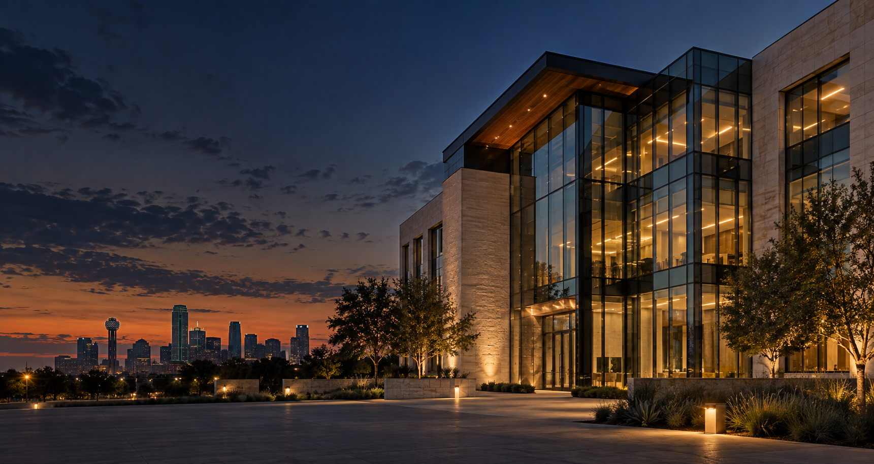 Warmly lit Dallas commercial architecture in stone and glass