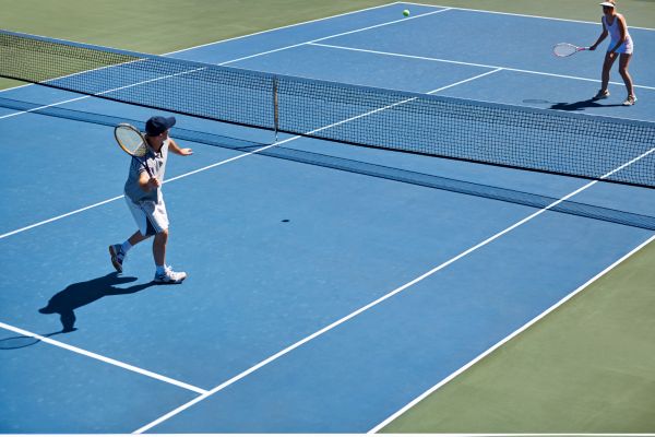 tennis player in action in blue tennis court tennis player in action in blue tennis court