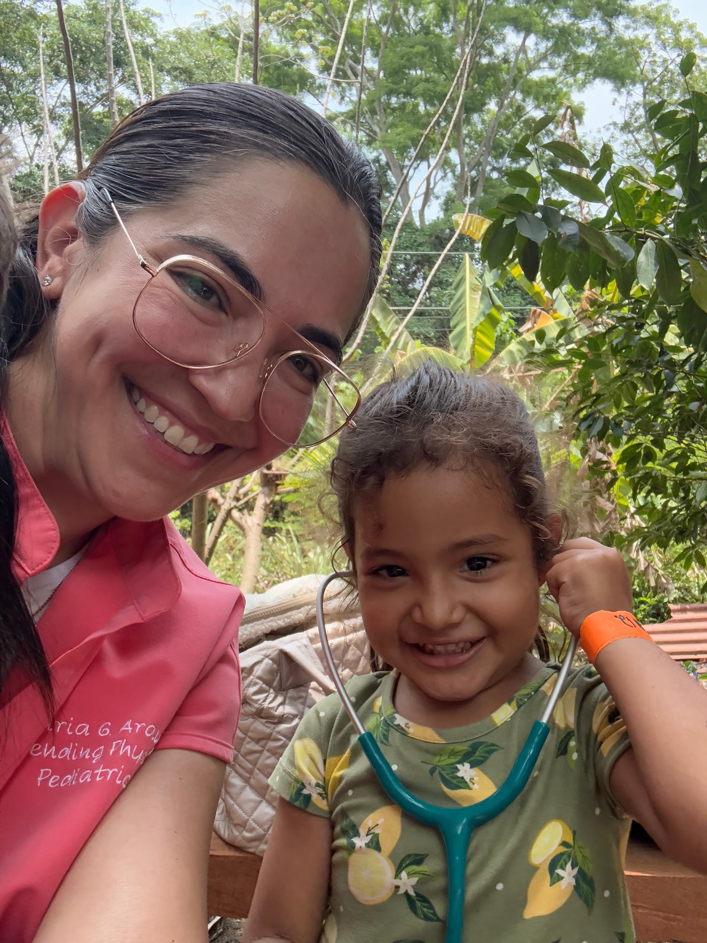 Dr. Maria with a young patient during a medical mission trip