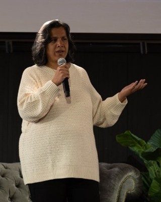 Dr. Julia Sen speaking on stage