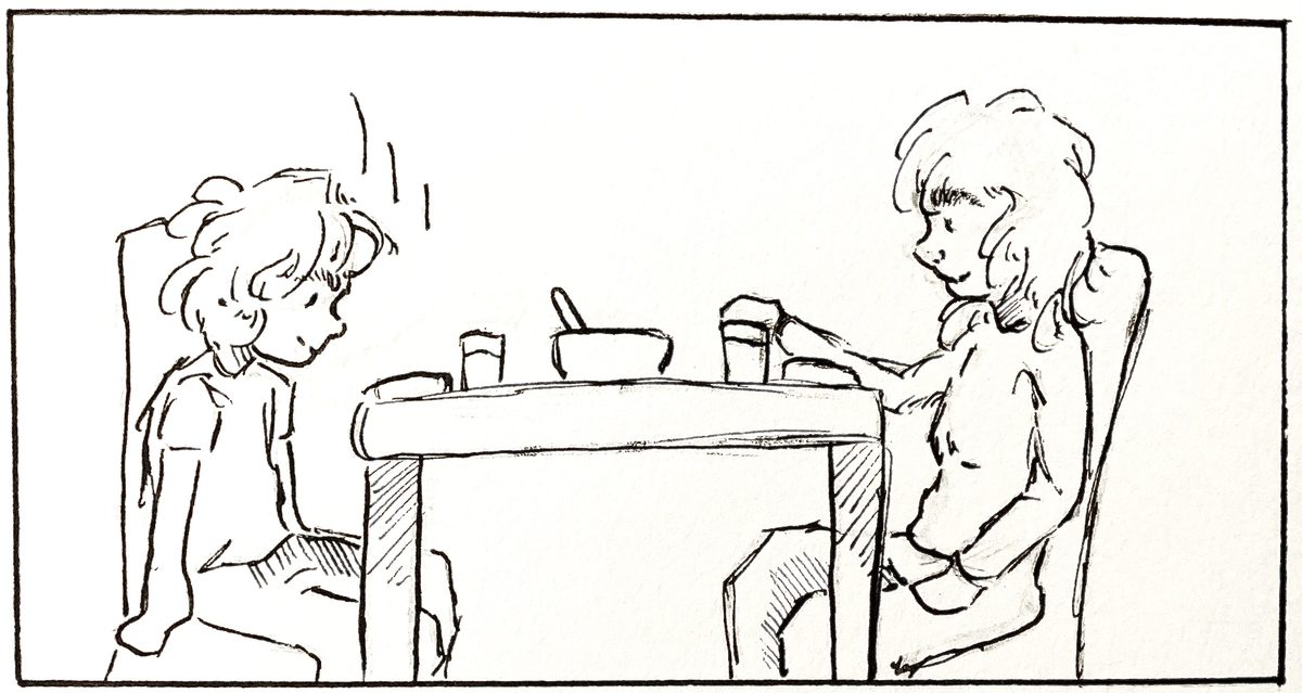 Child and parent sitting down to eat together