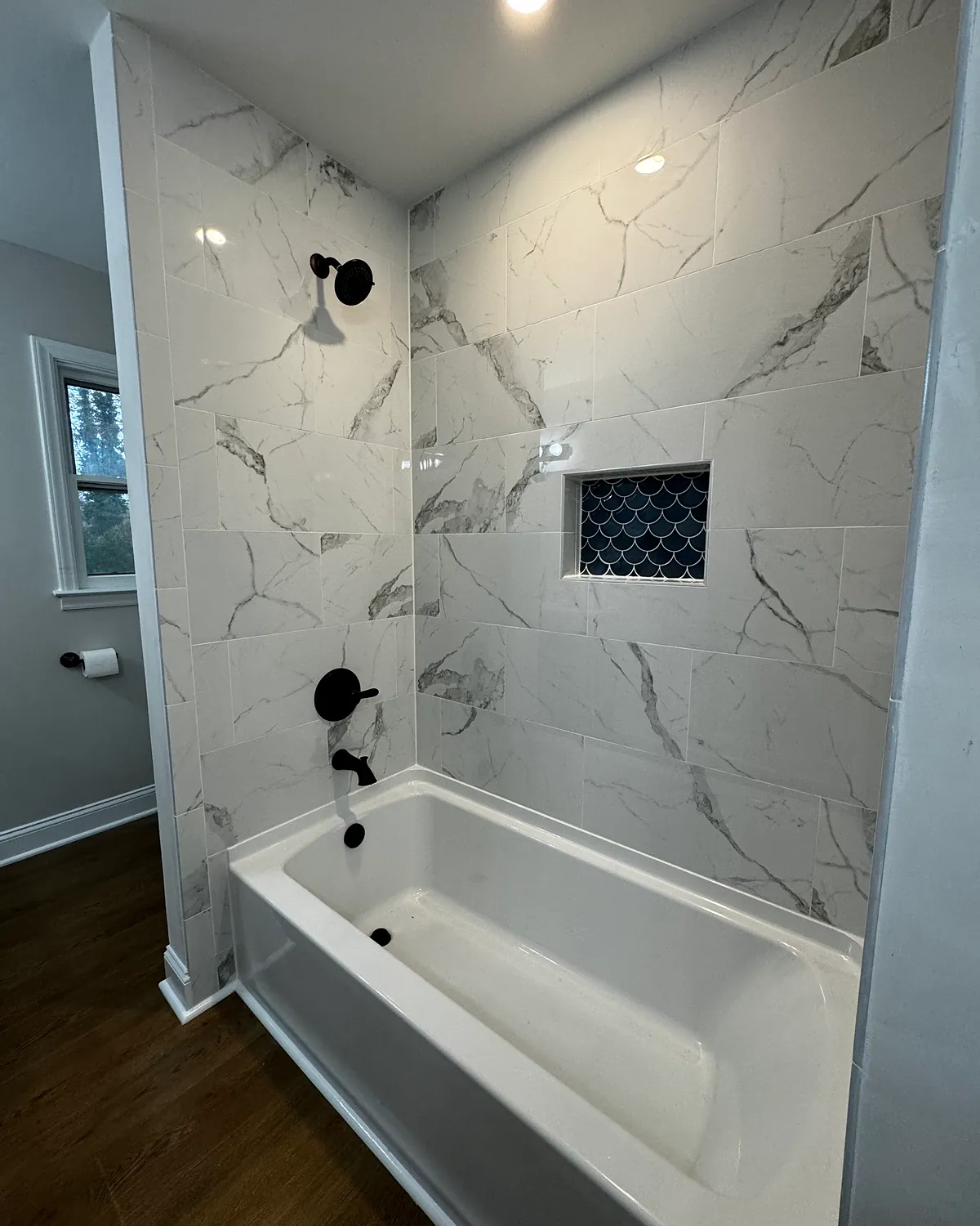 Tub and shower combination with marble-look tile
