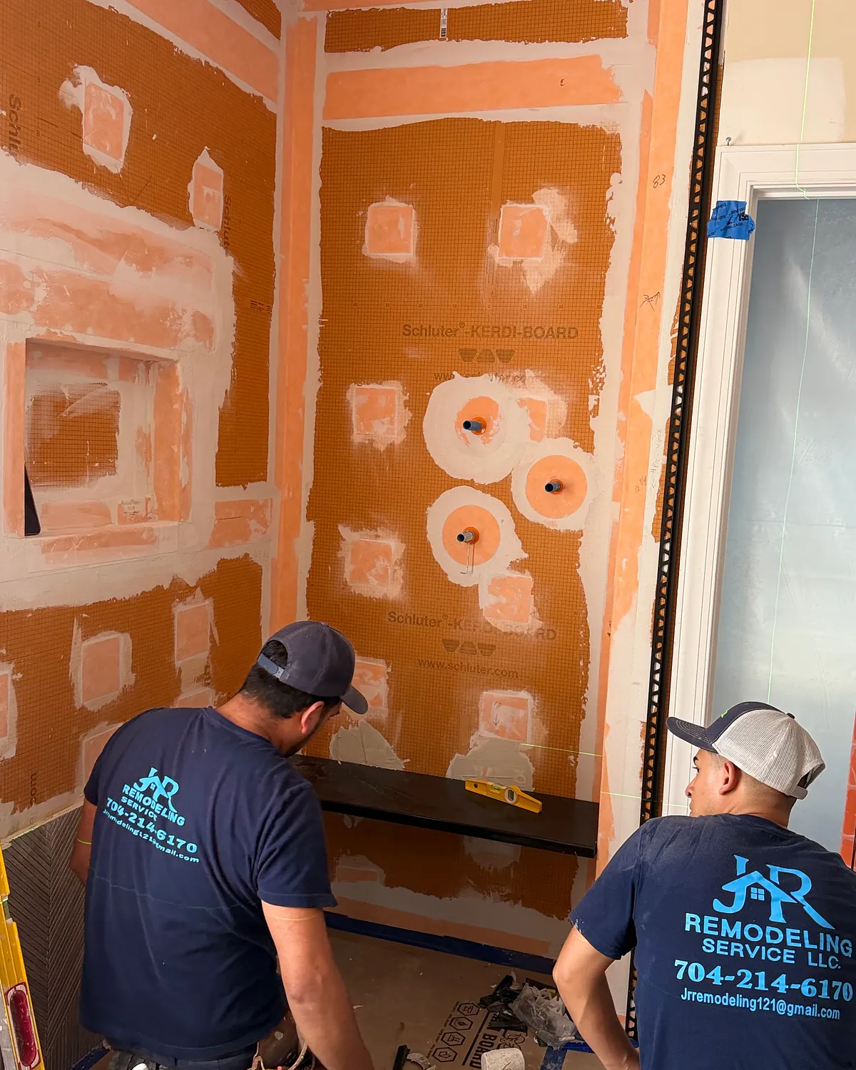 JR Remodeling crew installing a shower waterproofing system