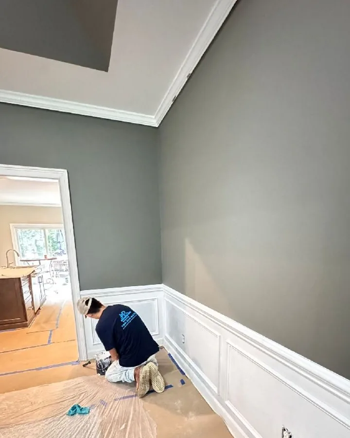 JR Remodeling crew finishing paint and wainscoting during an interior rebuild