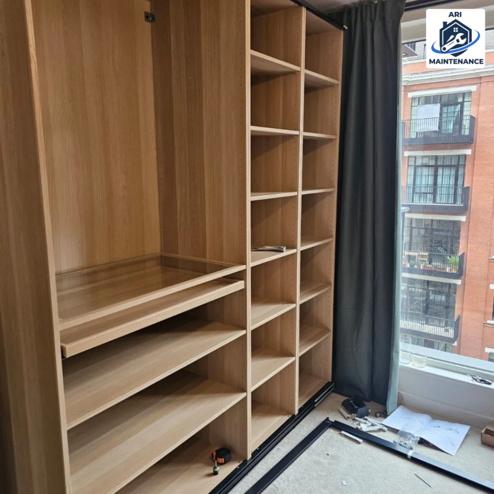 Built-in oak wardrobe install — mid-fit shelving and rails visible.