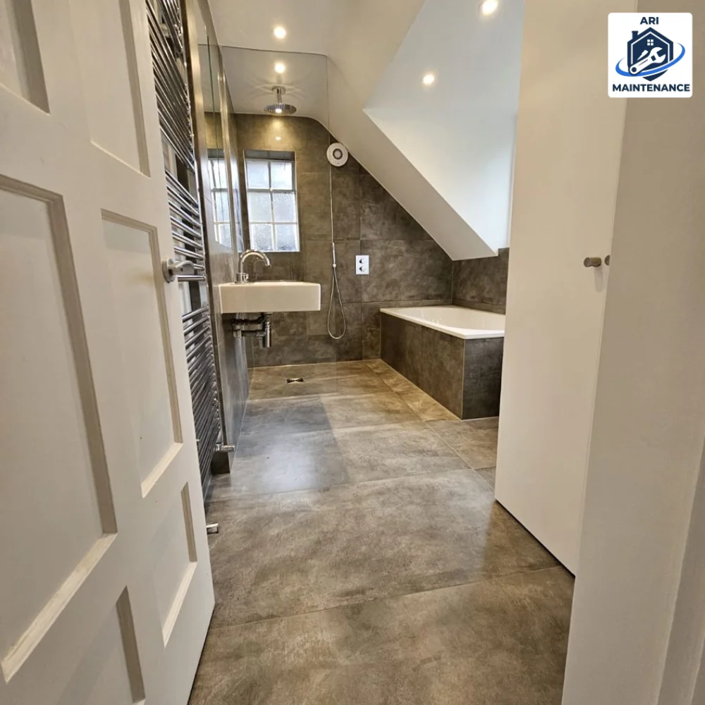 Premium polished concrete bathroom — wide view showing sloped ceiling skylight.