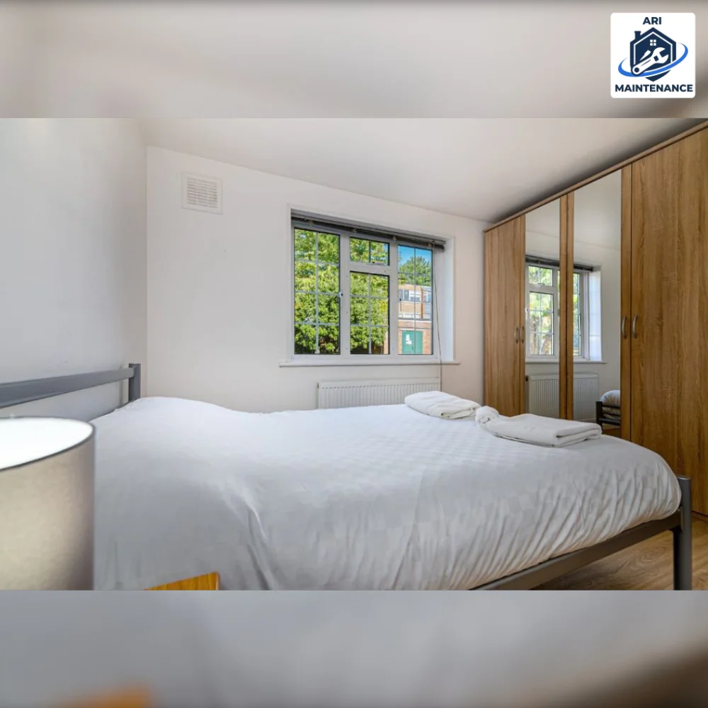 Refurbished bedroom with mirrored wardrobes and clean white styling.