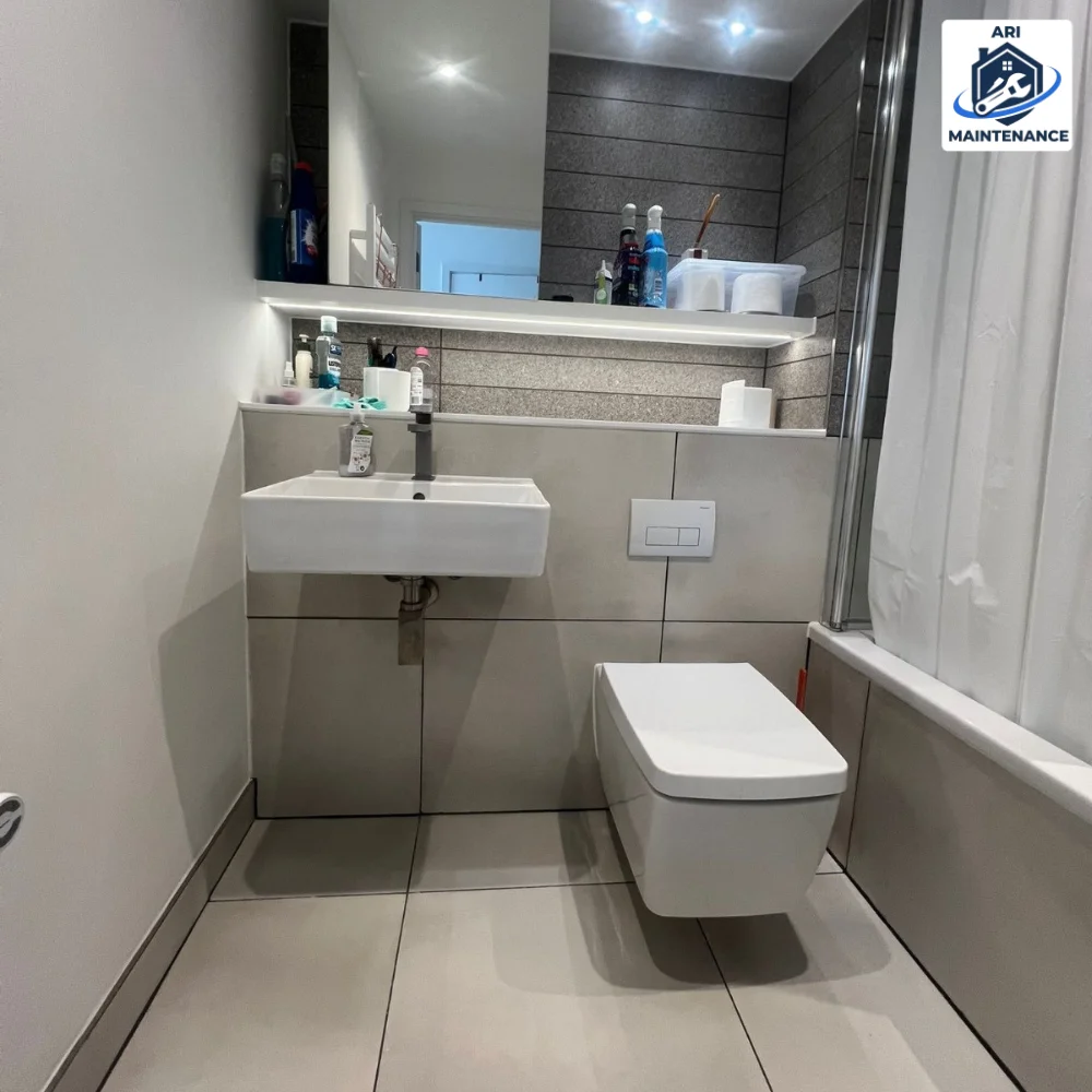 Modern grey bathroom with wall-hung WC and clean white sink.