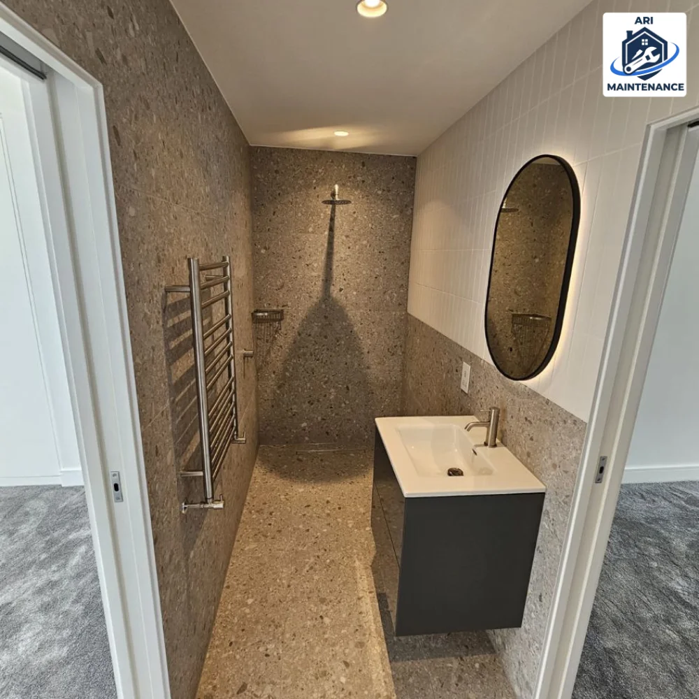 Same terrazzo shower from an alternate angle showing vanity context.