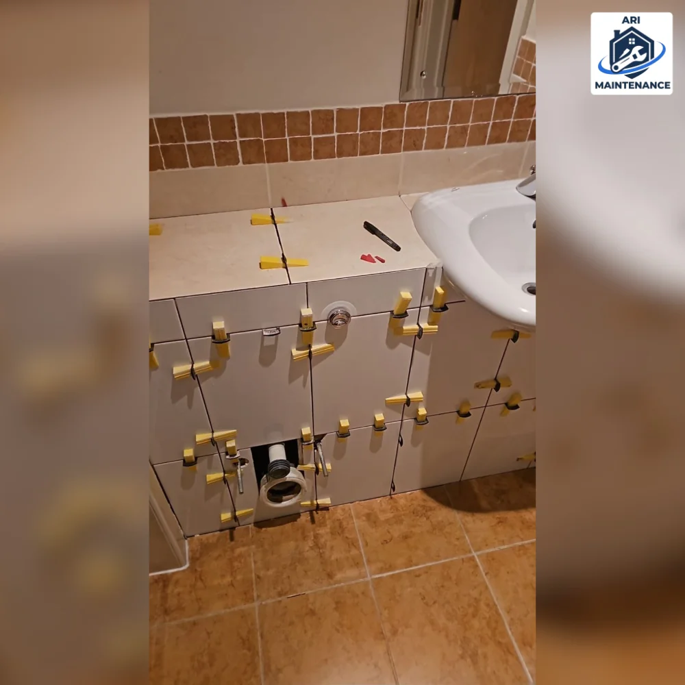 Rough plumbing pipework mid-install — copper fittings and gas-fitting visible.