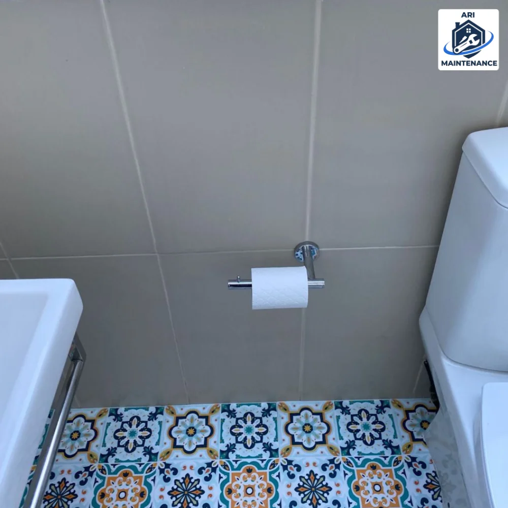 WC with matching Moroccan patterned floor tile.