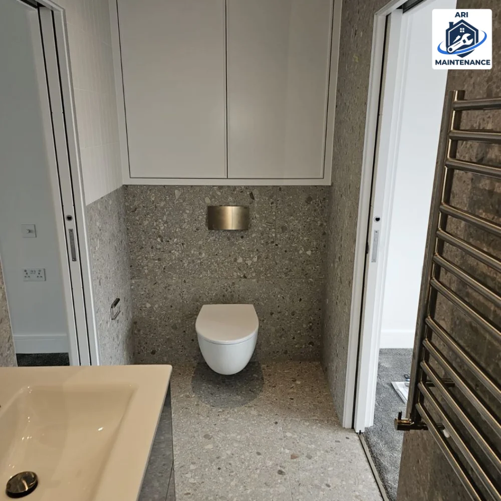 Wall-hung WC and vanity within a terrazzo bathroom suite.