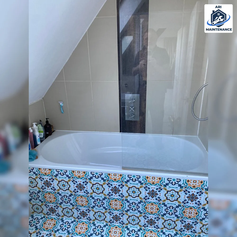 Bath with Moroccan patterned tile side panel.