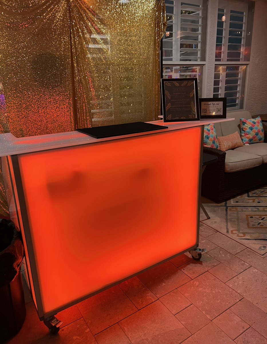 Orange illuminated mobile bar with a gold backdrop