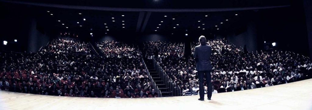 Fabio Marques on stage before a full tiered auditorium