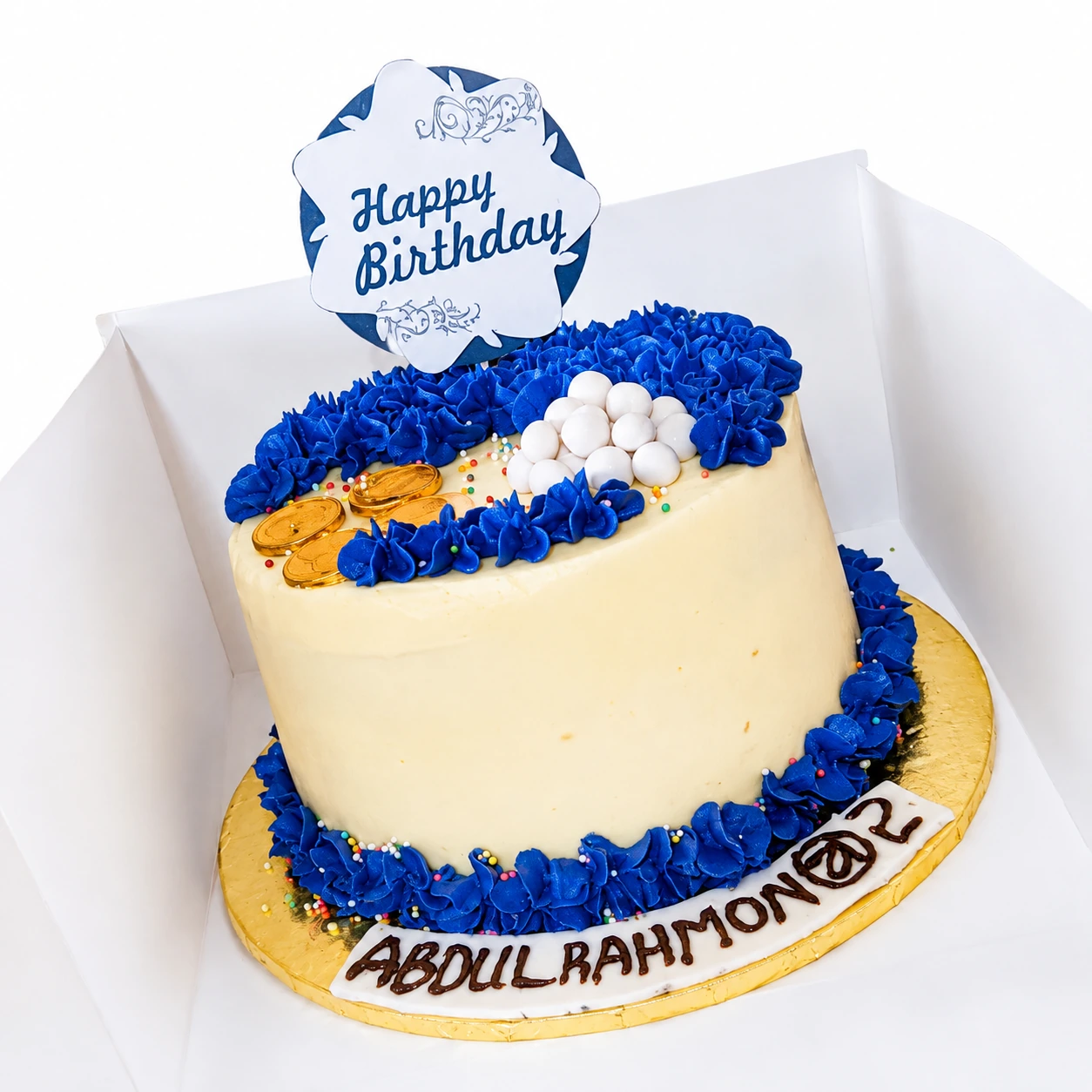 Blue and cream birthday cake with white chocolate balls and gold details