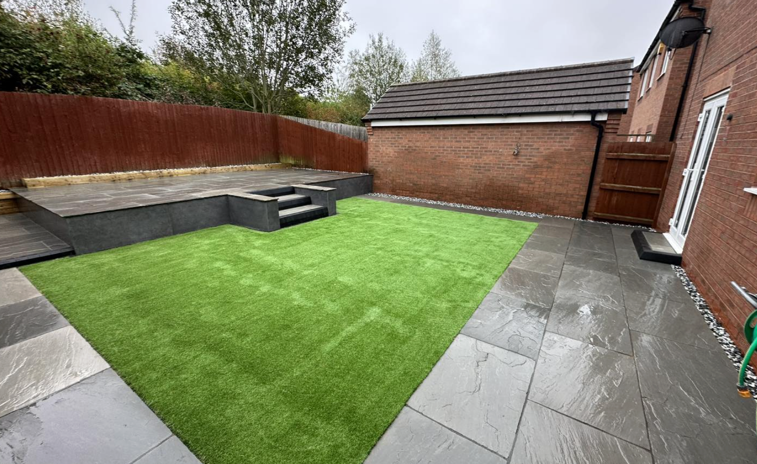 Neatly installed artificial lawn in a residential garden
