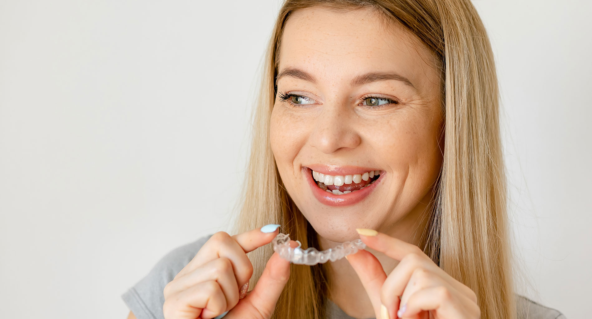 Woman holding invisalign