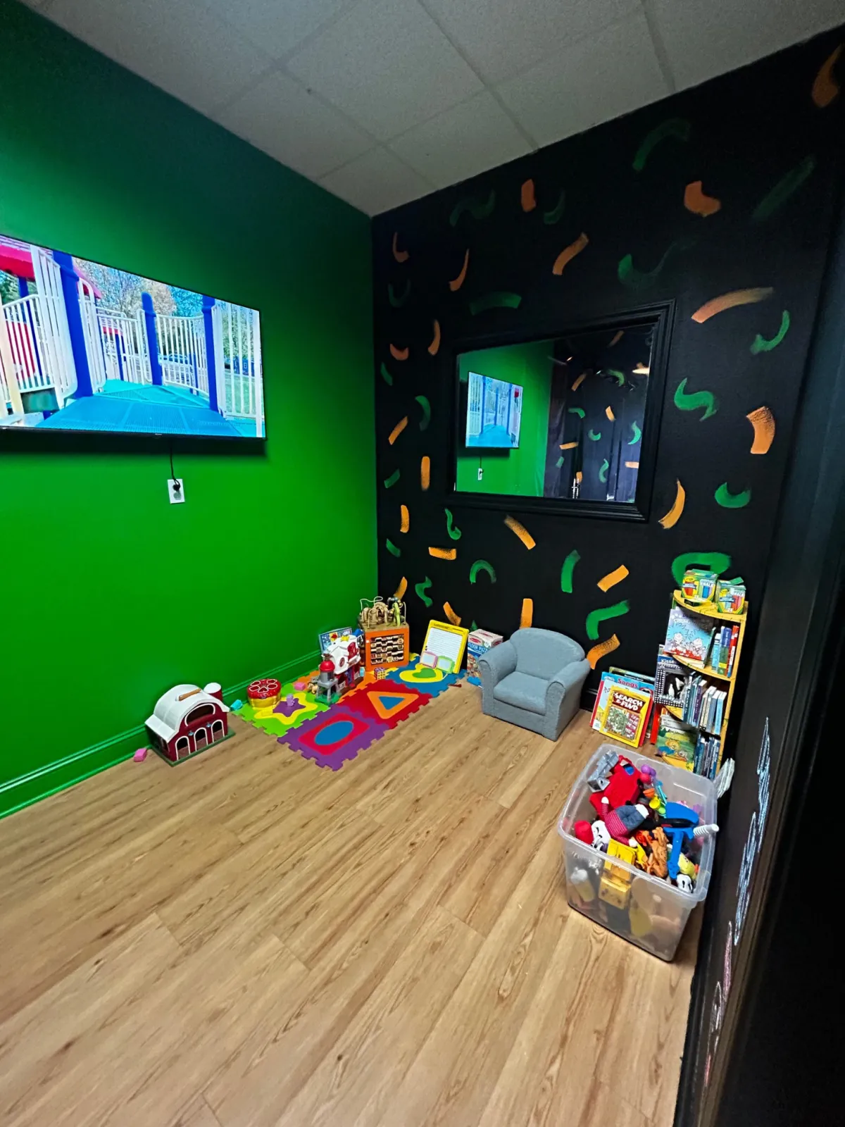 Kids play area at REFUEL Bootcamp Crestview with toys, books and a TV
