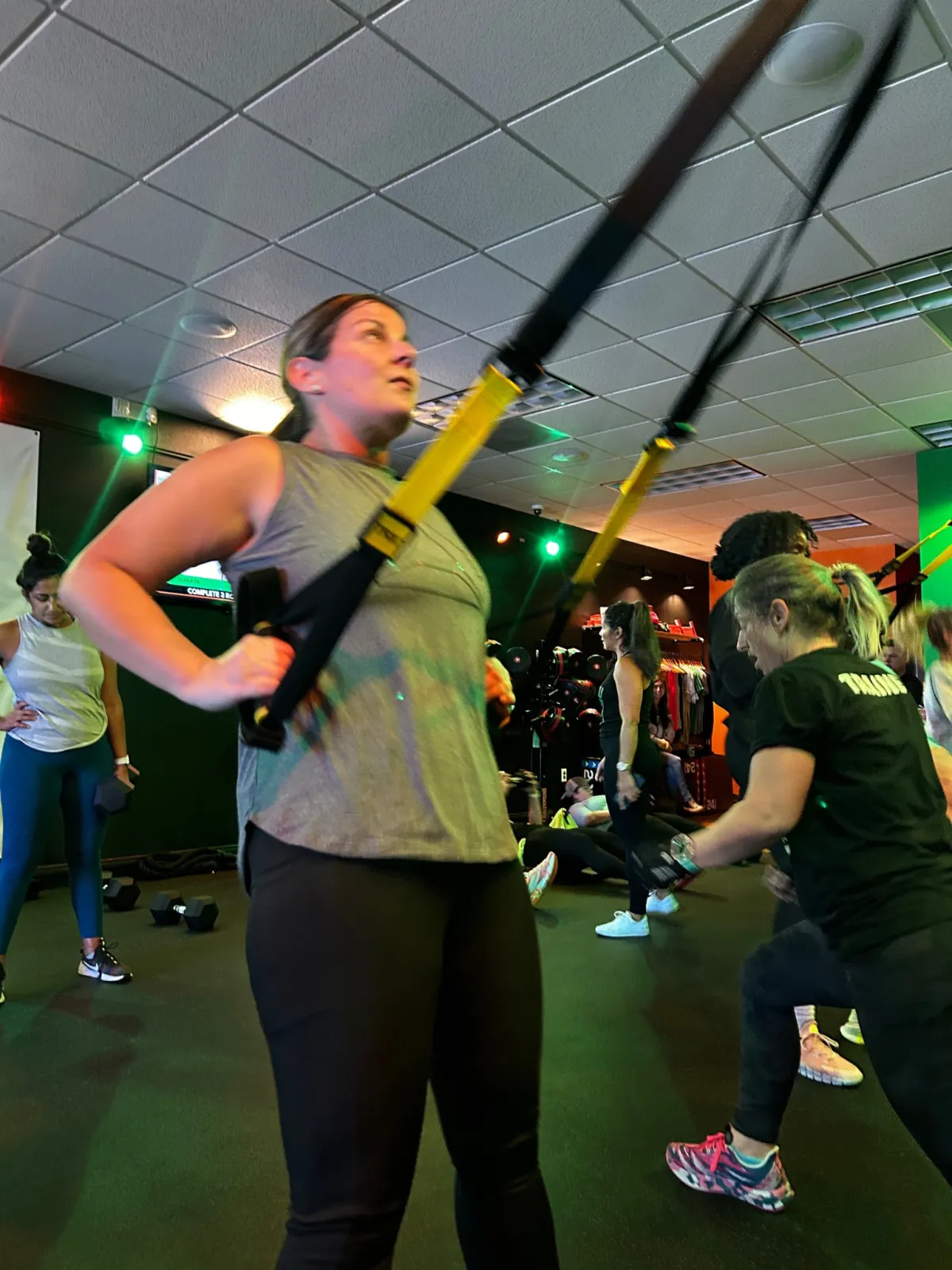 Members training with TRX straps in a class at REFUEL Bootcamp Crestview