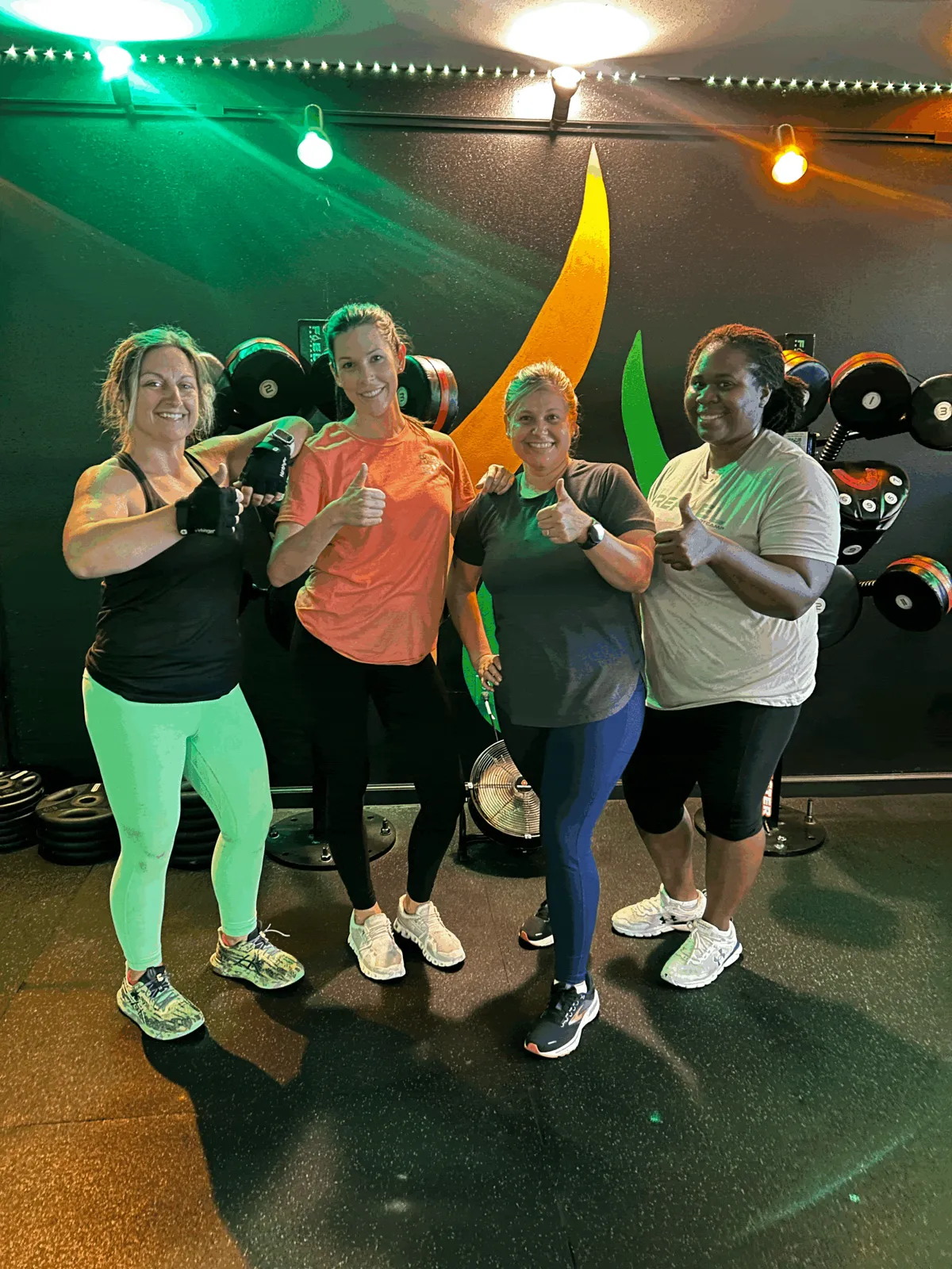Members posing in front of the REFUEL flame mural in Crestview