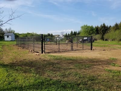 Farm-style chain-link fence installed around a rural property