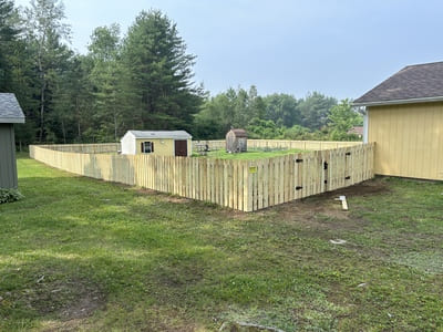 Secure wooden fence enclosing a residential property