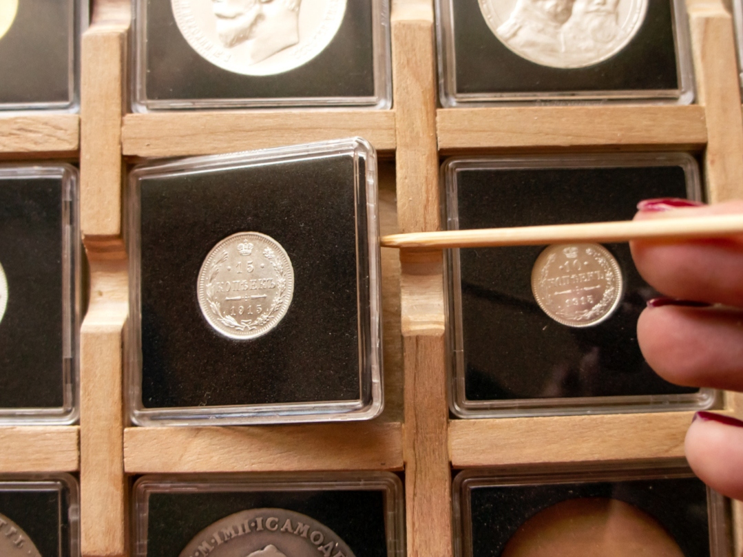Image of rare numismatic coins on separate container.
