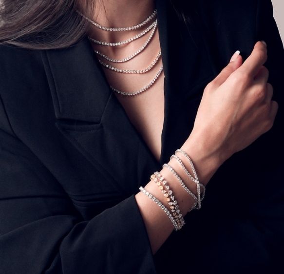 Costa's Fine Jewelry and Coins in Waukesha, WI. Image of a woman wearing jewelries making an offer.