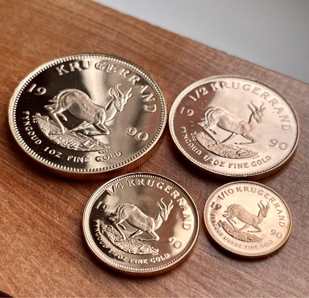 A collection of Krugerrand gold coins in various sizes, showcasing a passion for coin collecting, with each coin labeled by its denomination and weight.