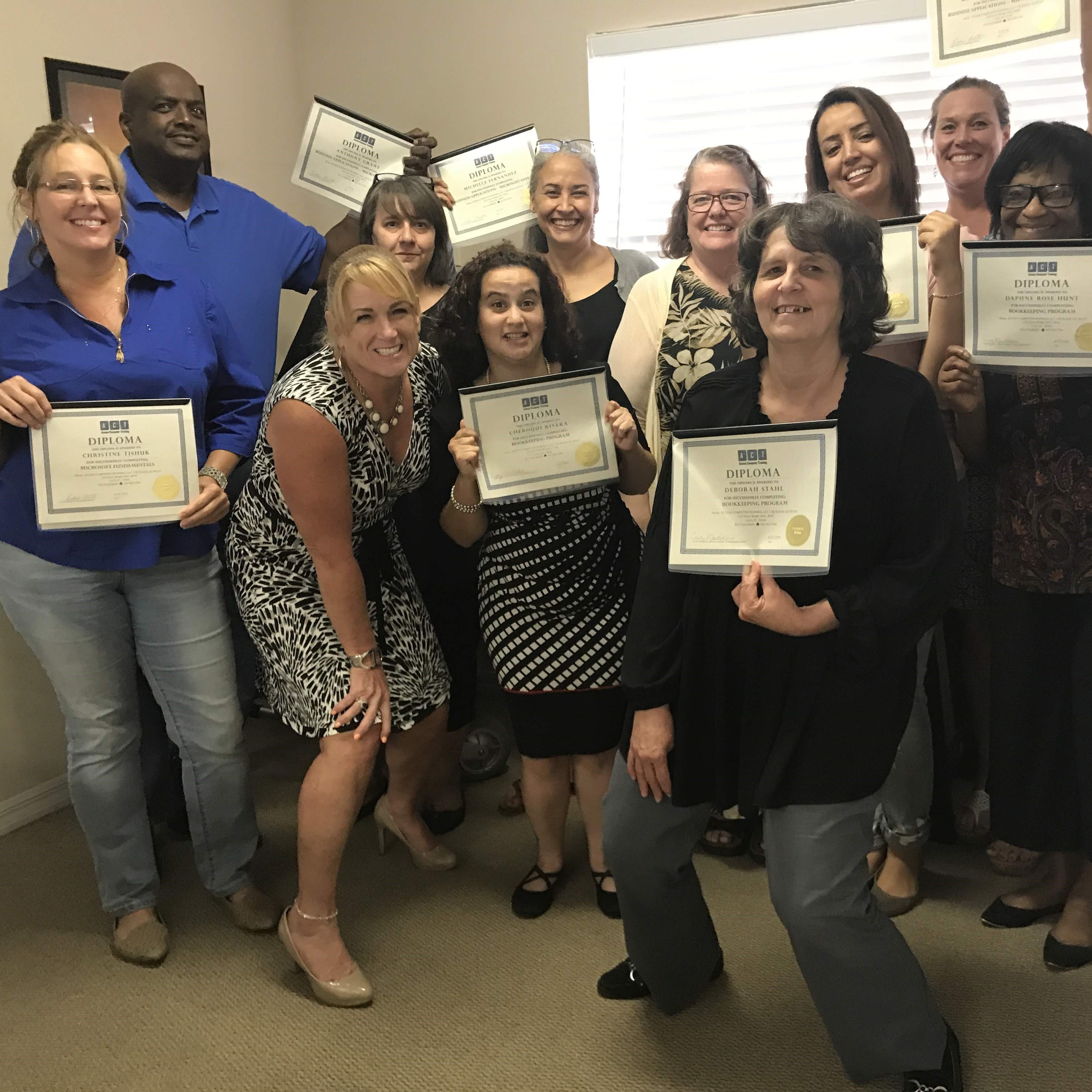 ACT graduates posing with founder Kristin Pelletier