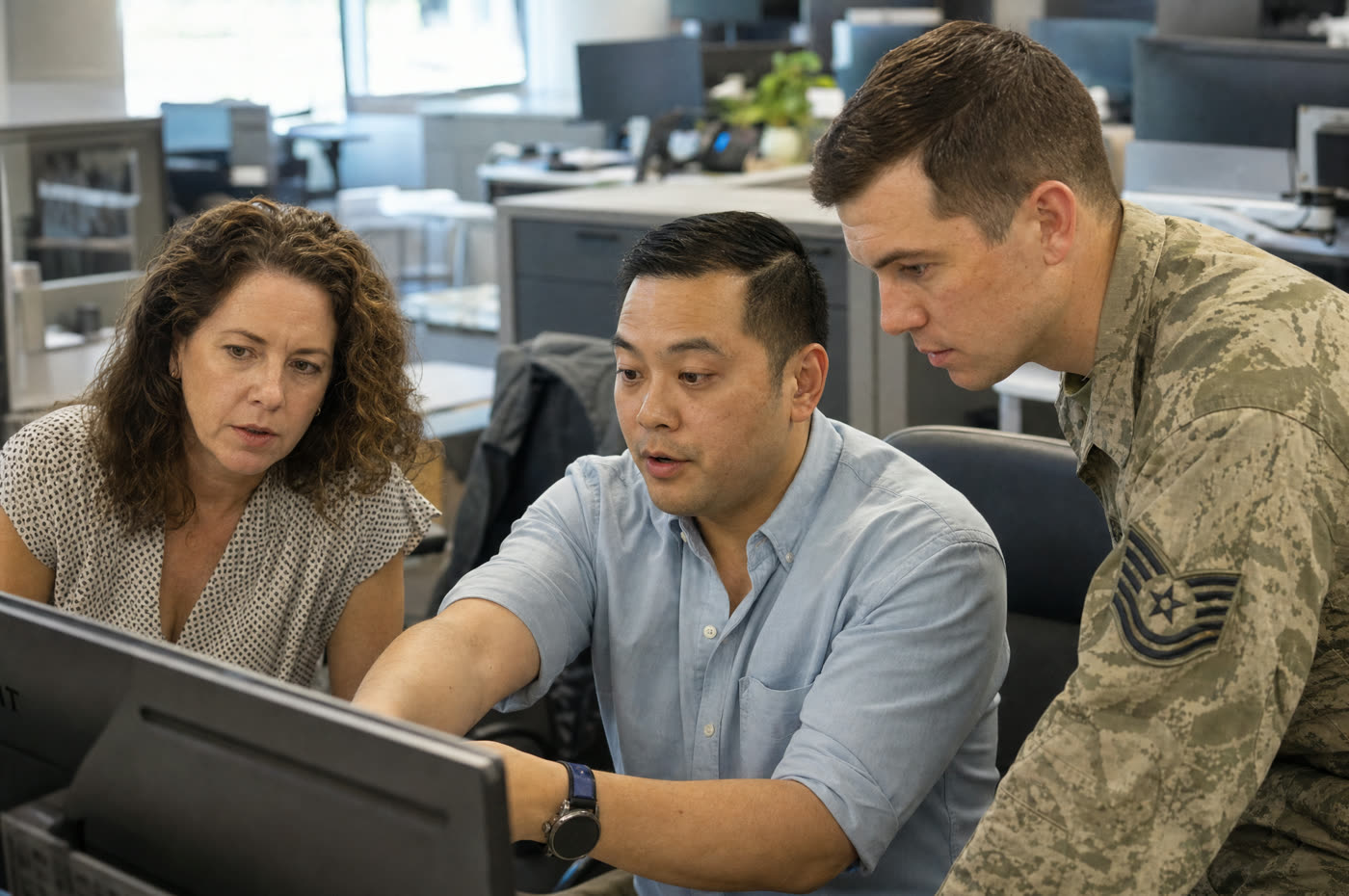 A blended team of civilian and military government staff collaborating on IT and cybersecurity training