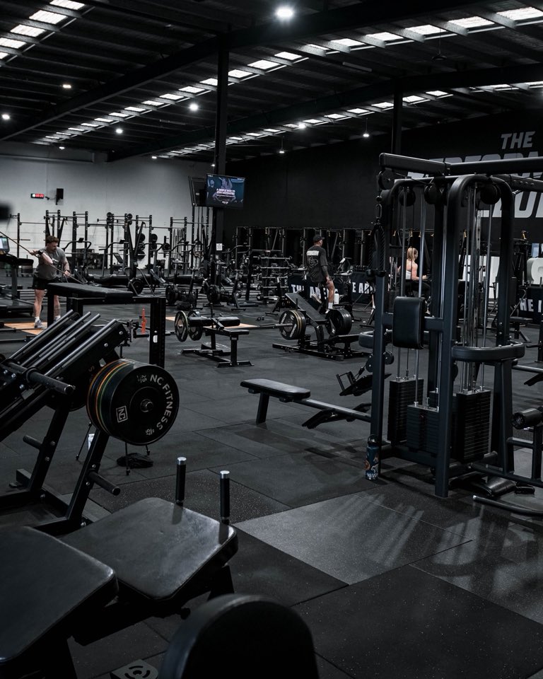 The training floor at The Performance Club: cable stacks, benches and racks