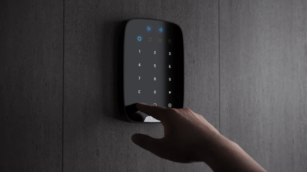 Ajax KeyPad Plus on the wall of a family home