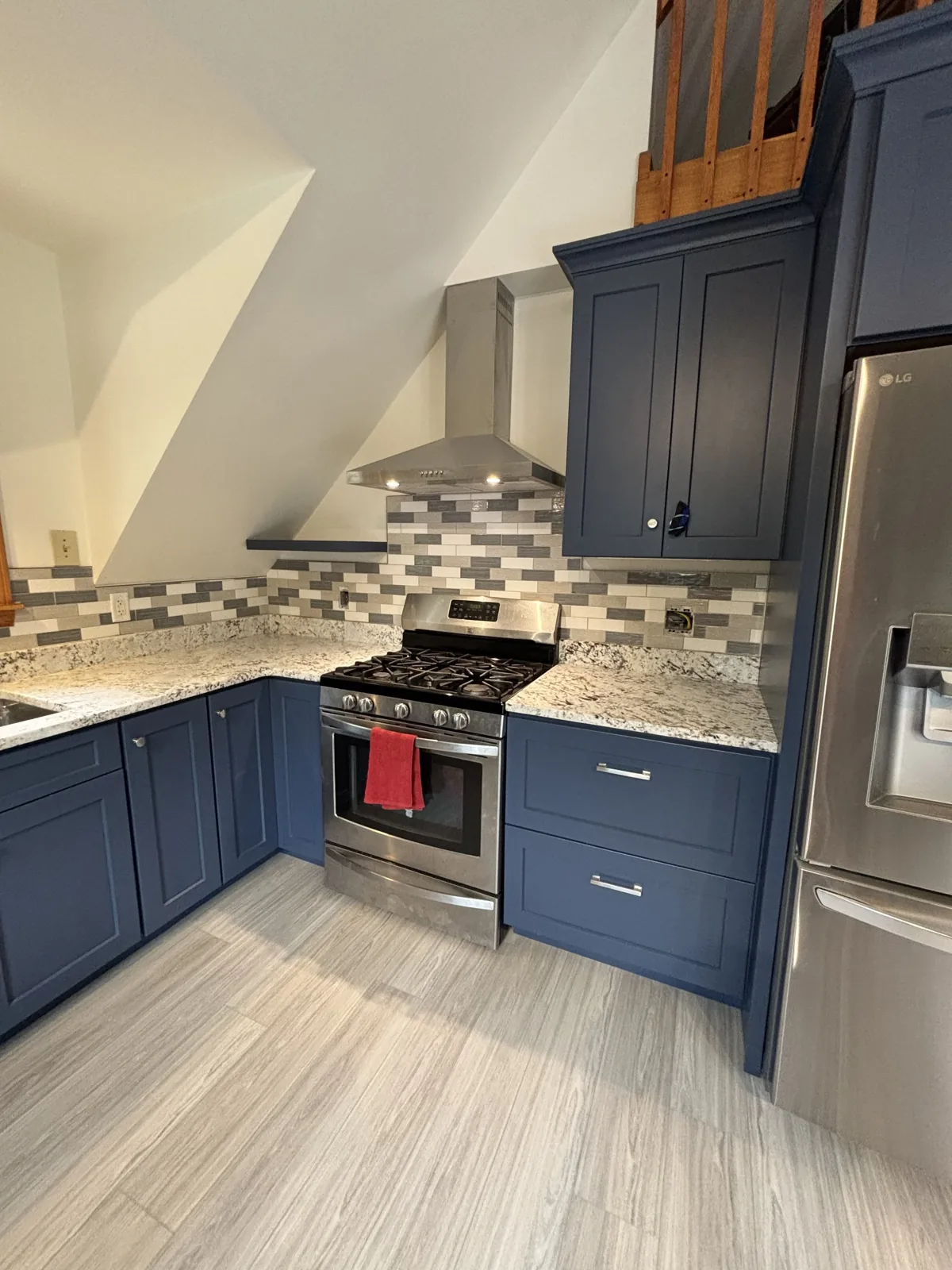 Remodeled kitchen with navy shaker cabinets in Greater Portland