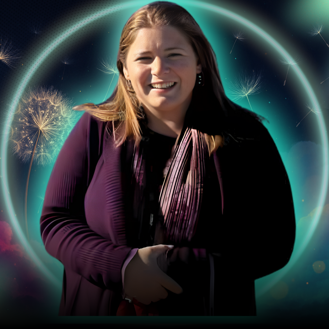 A smiling South Asian woman in her 40s, wearing a teal blouse, seated at a modern desk with a laptop and colorful sticky notes. The setting is a bright, organized workspace, radiating warmth and expertise.