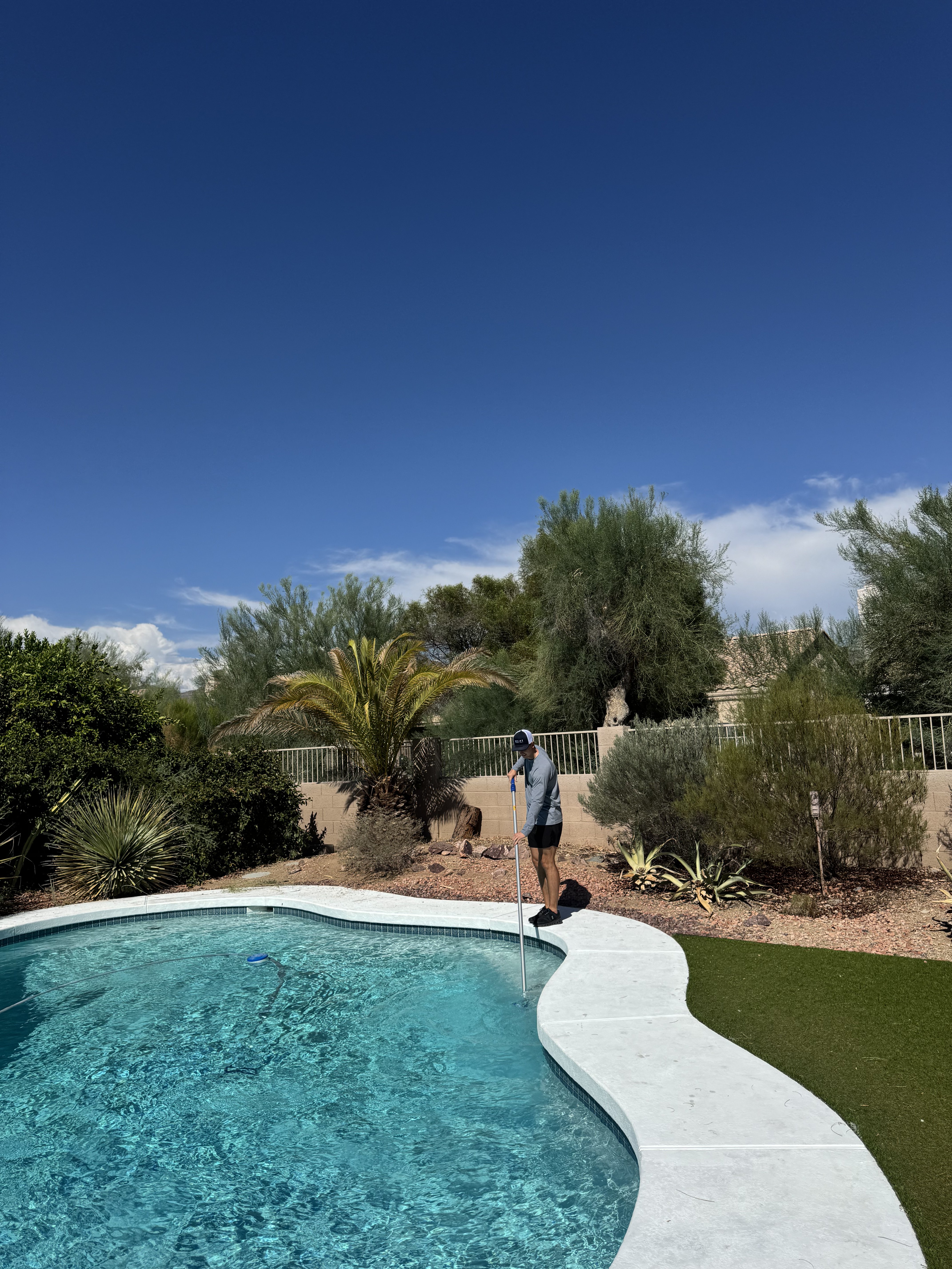 Colton skimming a residential pool in Scottsdale, Arizona