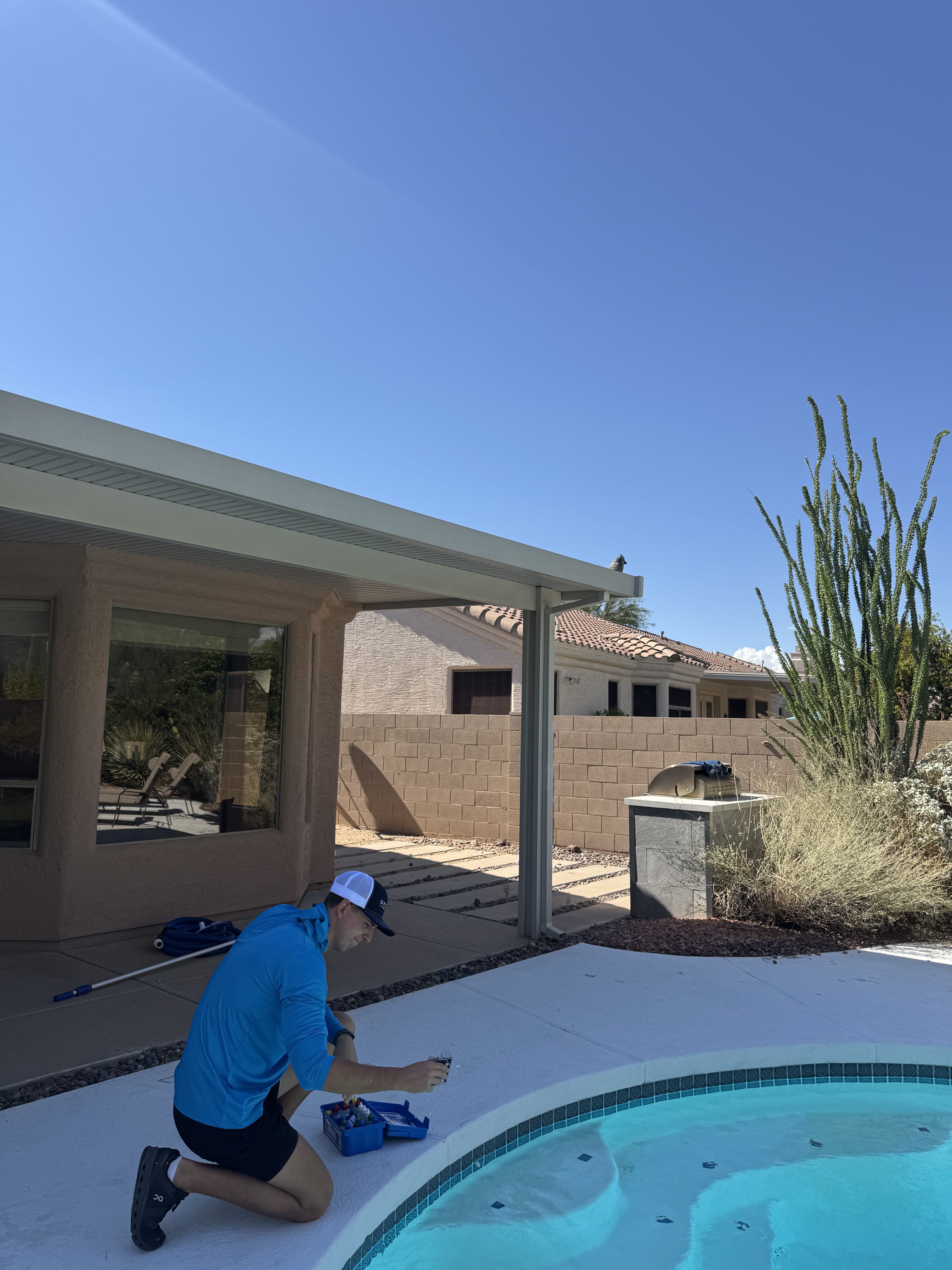 Drift Pool Co. technician in branded uniform poolside