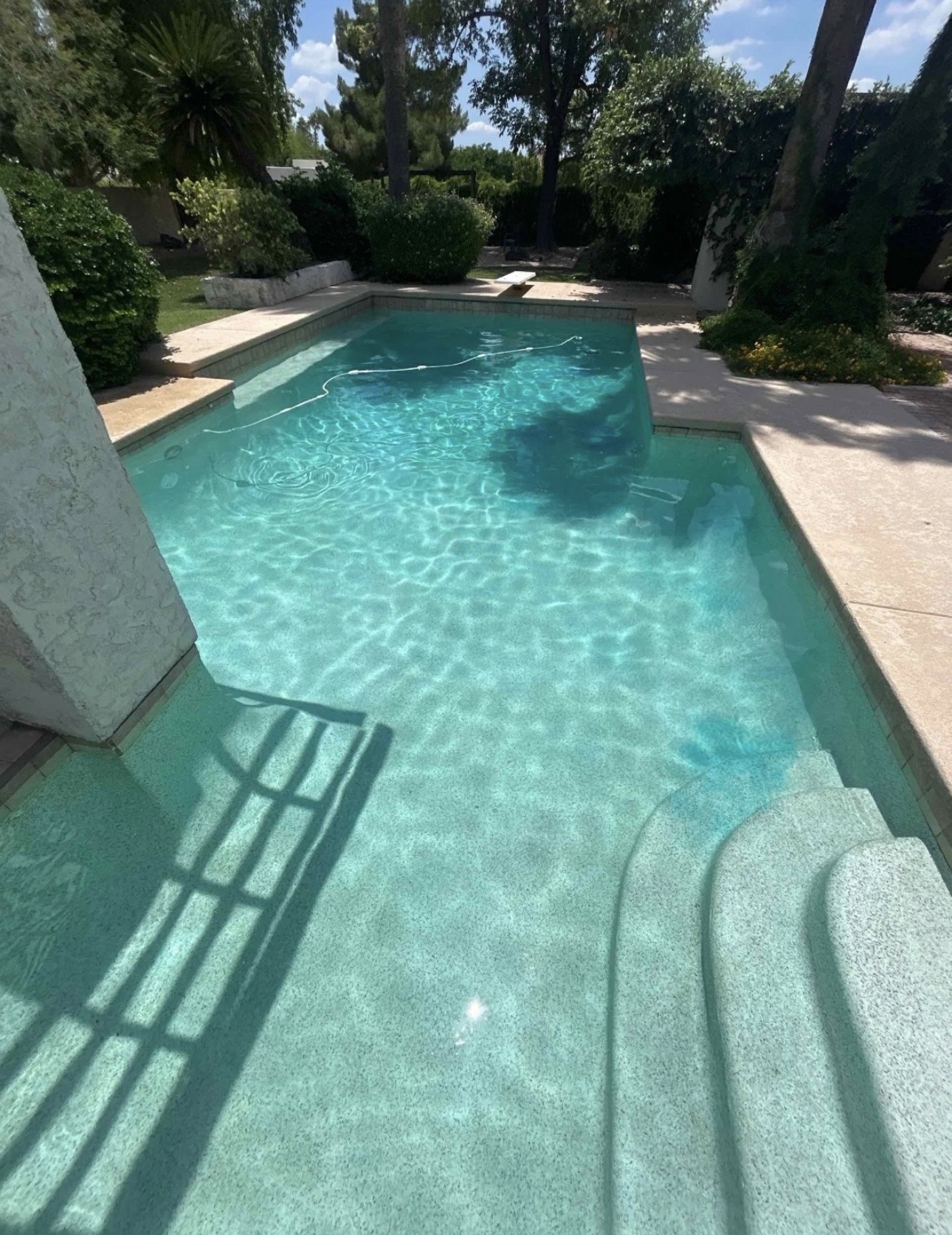 Backyard pool cleared of leaves and debris after Drift Pool Co. weekly service