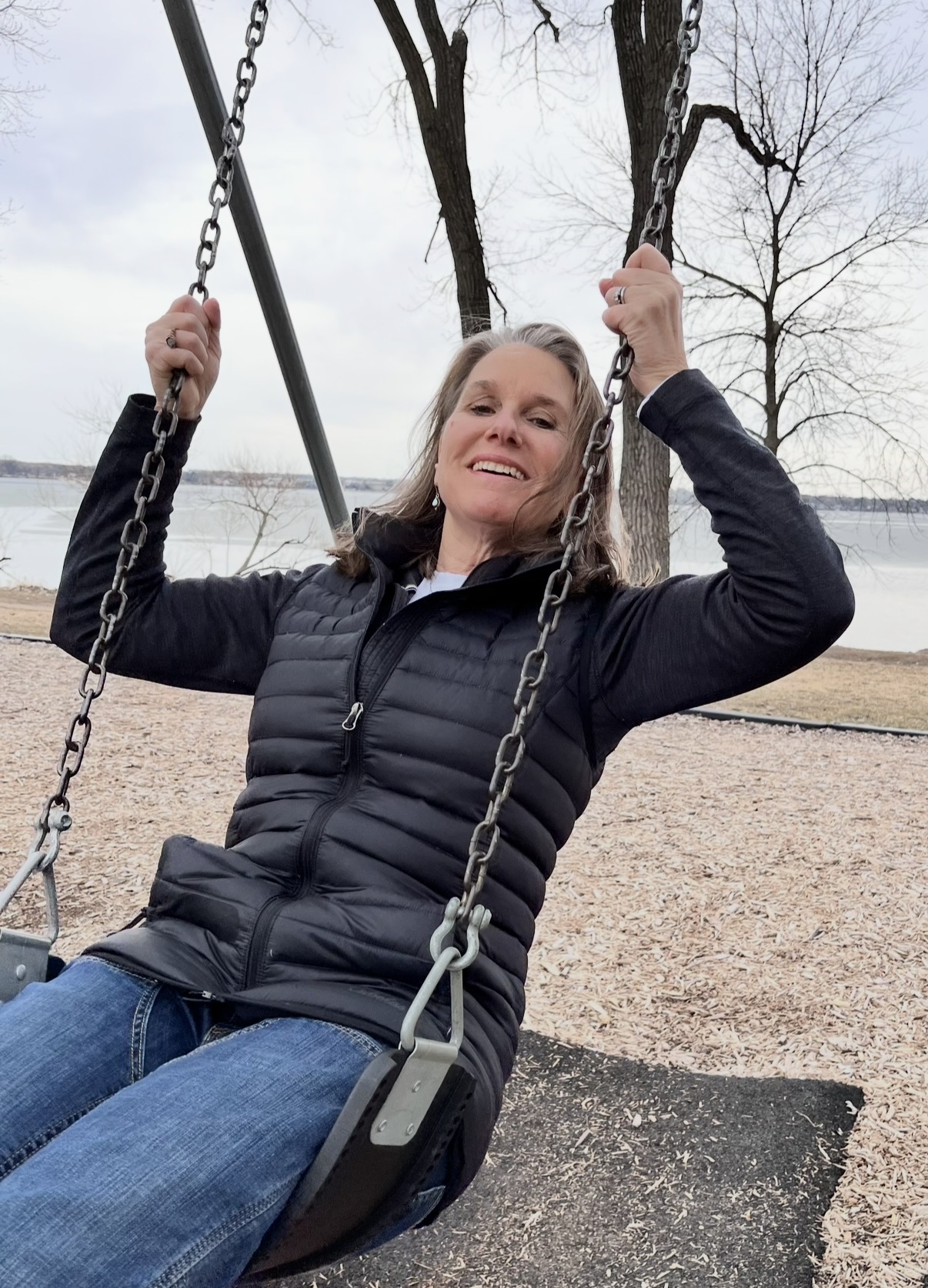 Coach Joy on a swing at the park