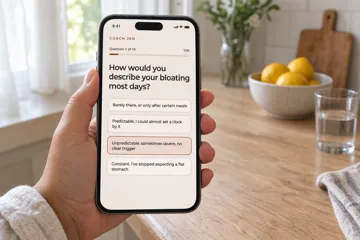 A hand holding a phone that shows the first question of the gut quiz