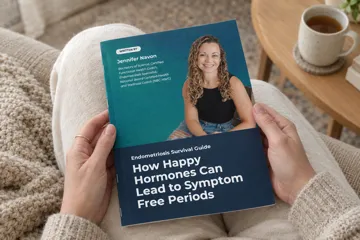 A woman holding a printed copy of The Endometriosis Survival Guide on her lap