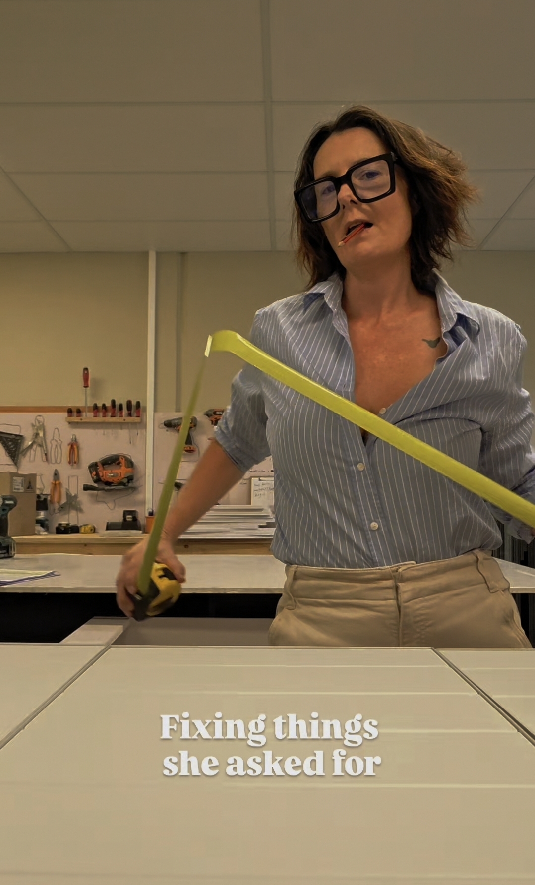 Ali with a tape measure in the workshop