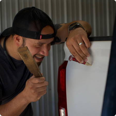 Technician removing dent from car panel in Tyler