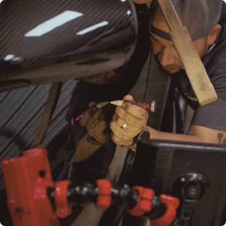 Technician removing dent from car panel in Tyler