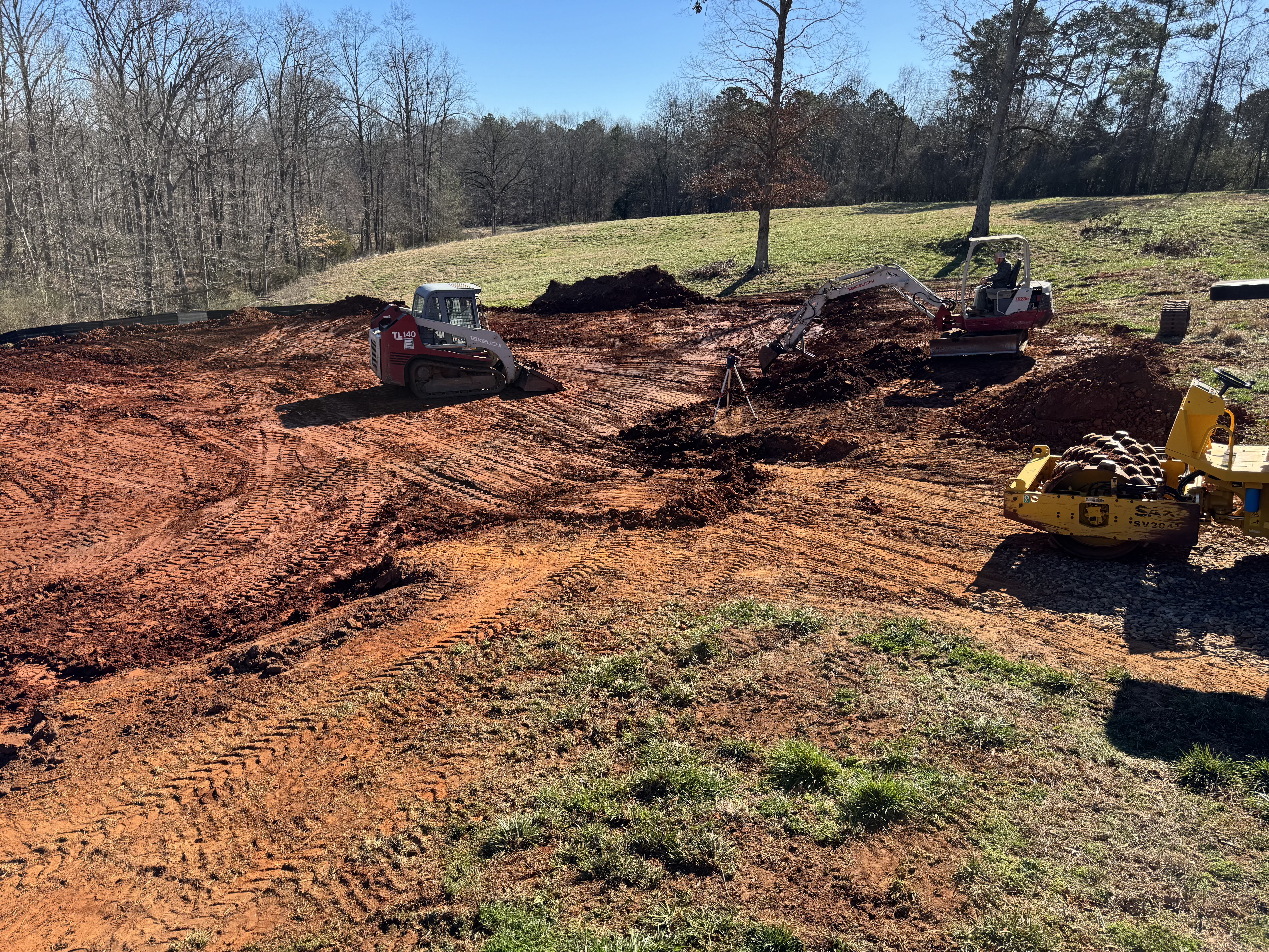 Equipment grading a building pad