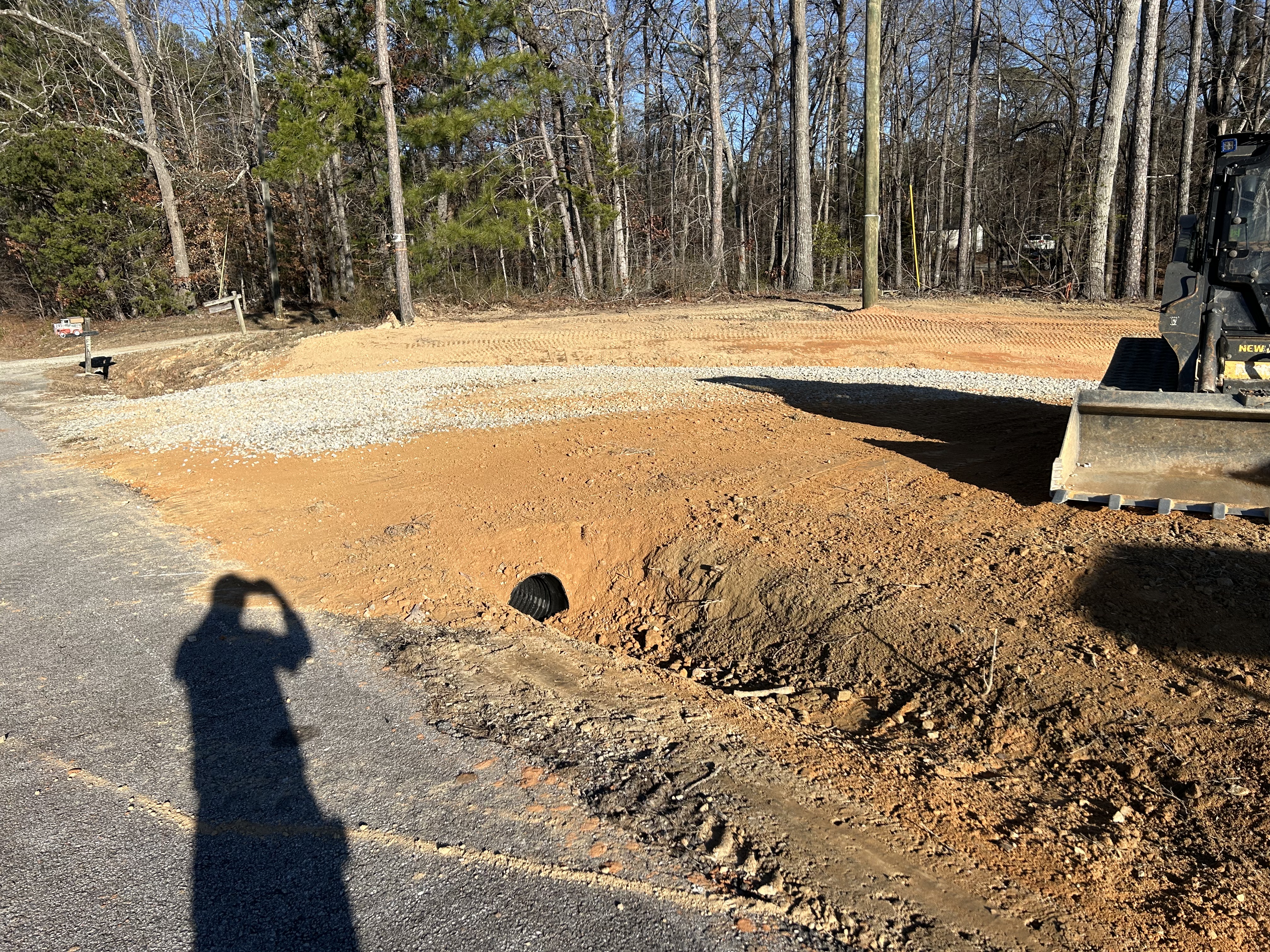Driveway apron with a culvert pipe