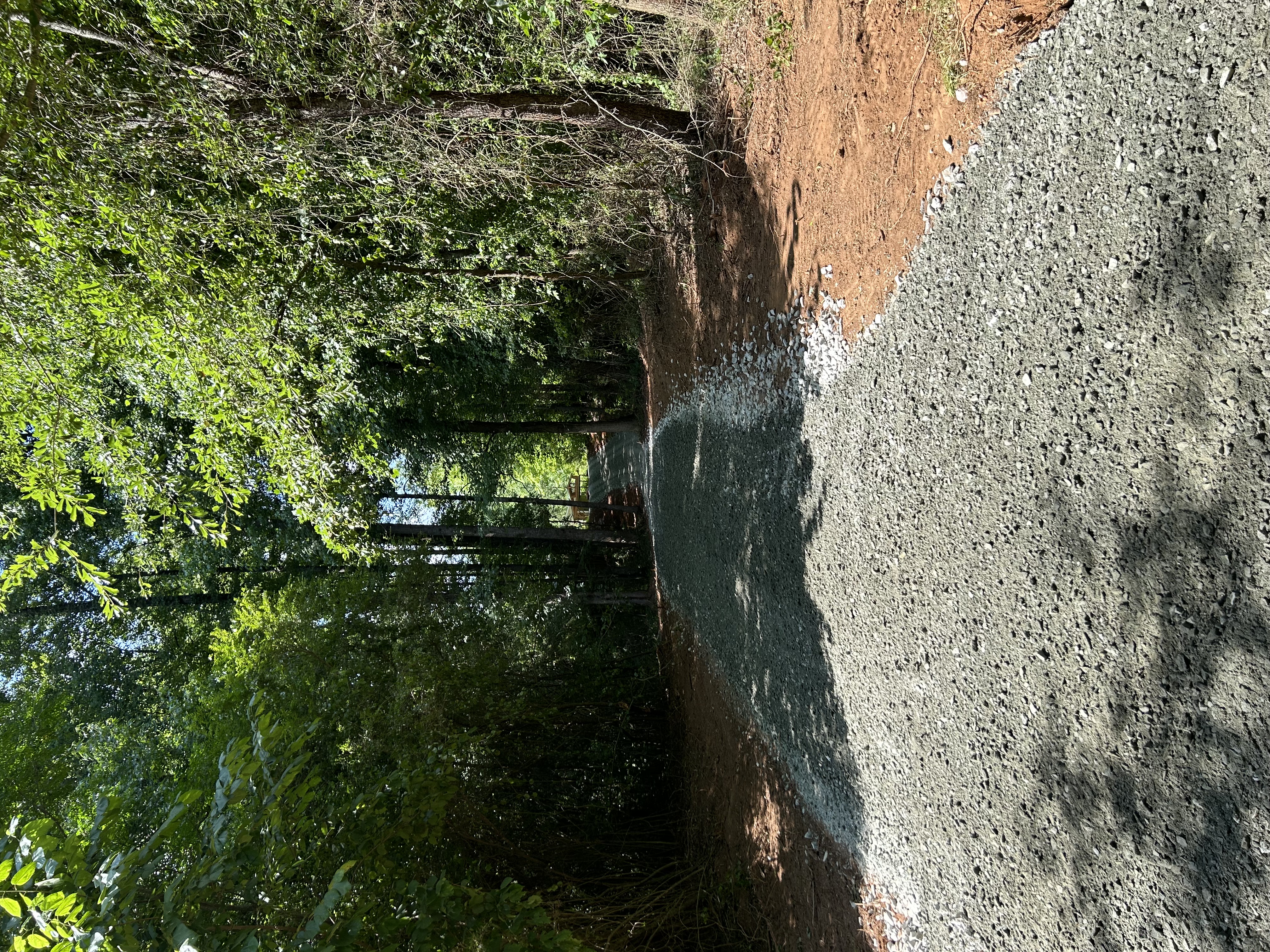 New gravel driveway on a wooded lot