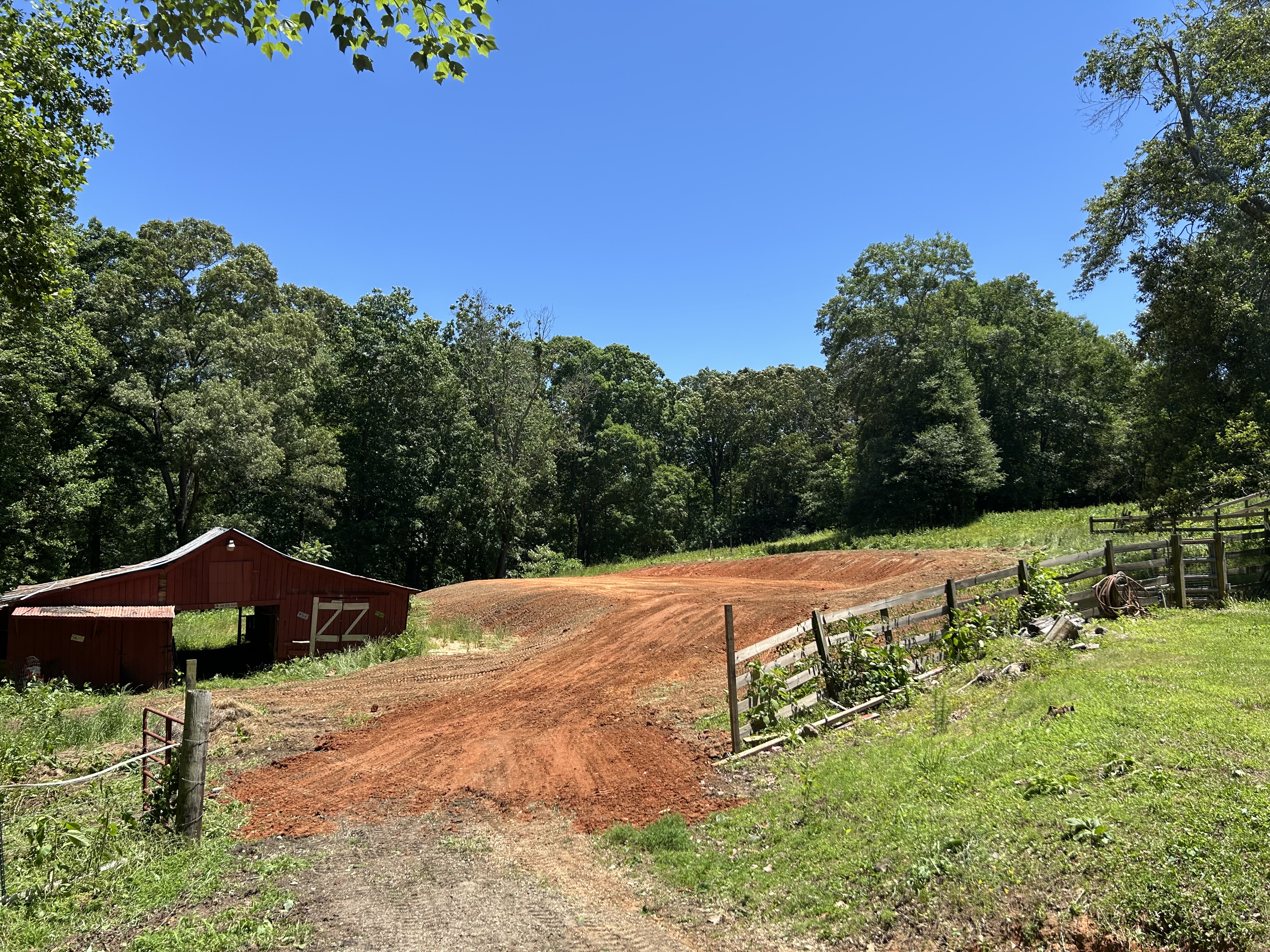 Graded pad beside a barn